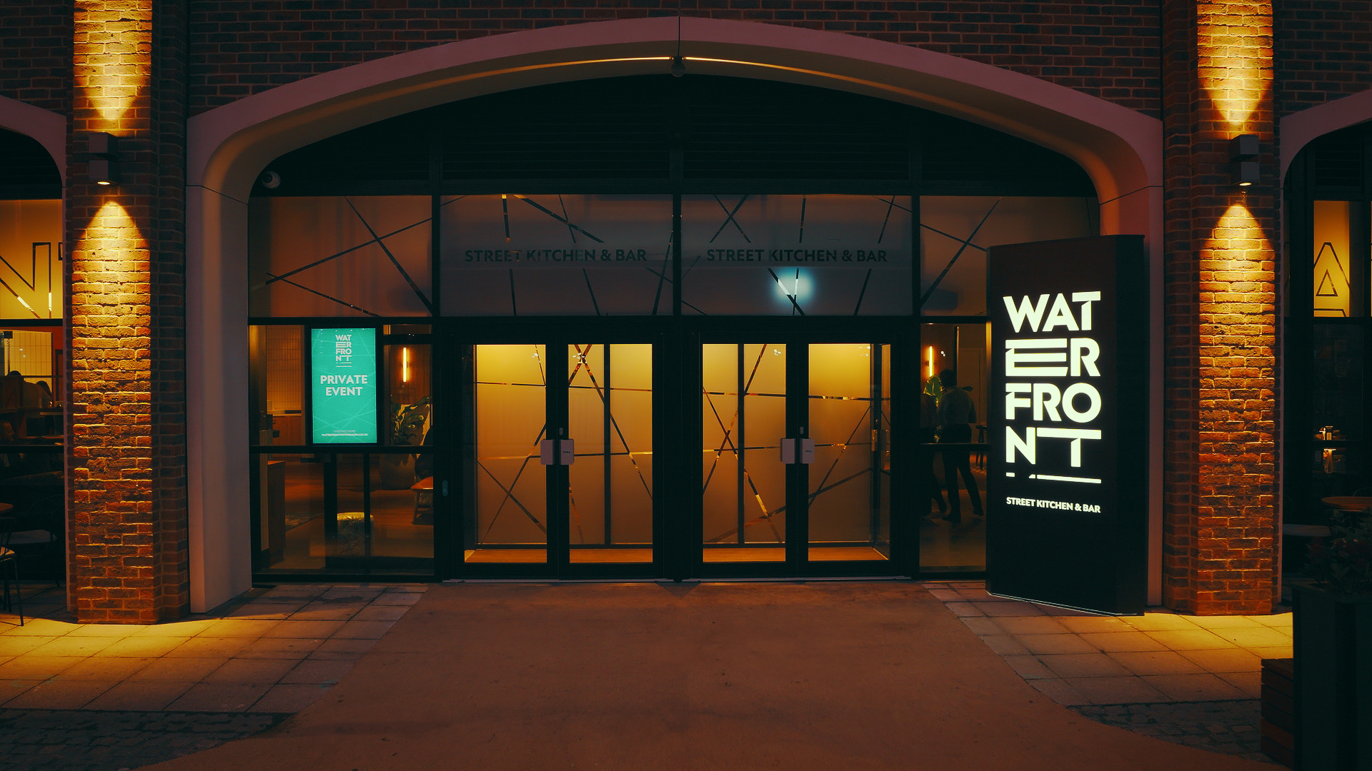 Waterfront Street Kitchen & Bar at ExCeL London, lit up at night